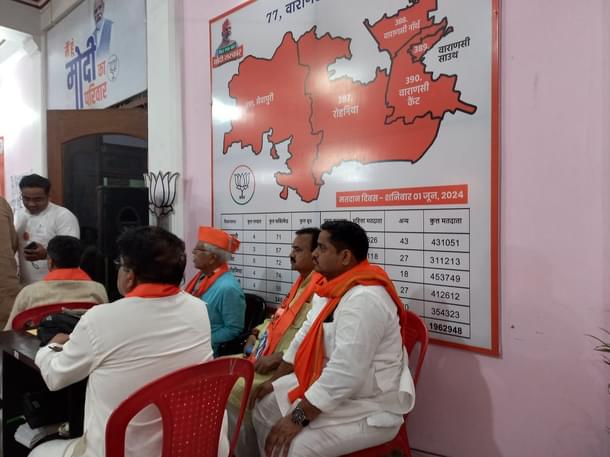 BJP workers sitting next to a map of the Vidhan Sabha segments falling under the Varanasi Lok Sabha constituency (Image credit: Sumati Mehrishi)